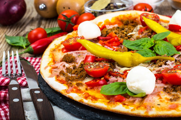 Rustic Italian Pizza on a Thin Pastry with Minced Pork, Ham, Tom