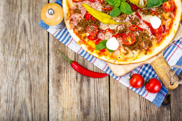 Rustic Italian Pizza on a Thin Pastry with Minced Pork, Ham, Tom