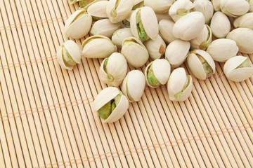 Pistachio nuts on bamboo background