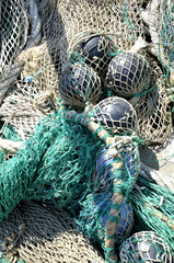 fishing nets deposited on the dock to dry