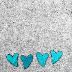 Wooden hearts on gray felt background, copy space