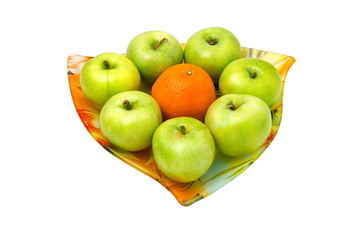 green apple and an orange in the middle on a tray against white background