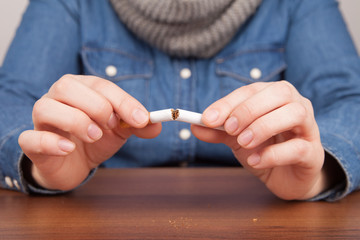 Frau bricht Zigarette durch