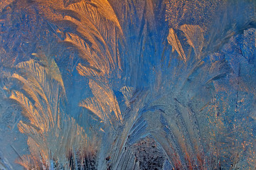 Icy frosty ornate pattern of thin ice on the window