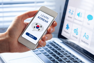 Learn Korean language online concept, mobile phone, flag of South Korea © NicoElNino