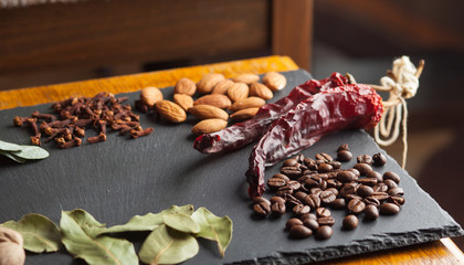 nuts, spices and food on a wooden tray