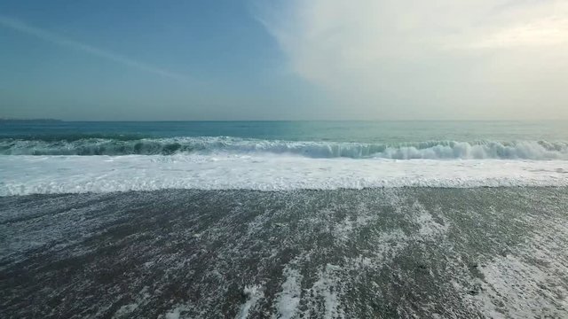 Drone flying over wavy sea, aerial shot