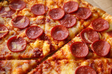 Pepperoni pizza. Hot homemade food. Sliced fresh italian classic salami pizza. Popular topping with cheese. Baked meal.