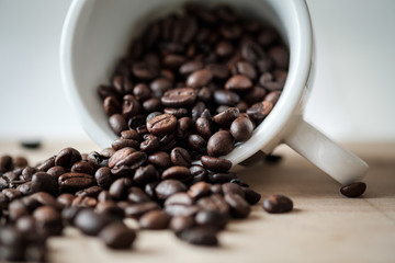 Detail view of coffee beans on wooden background. Macro shoot.