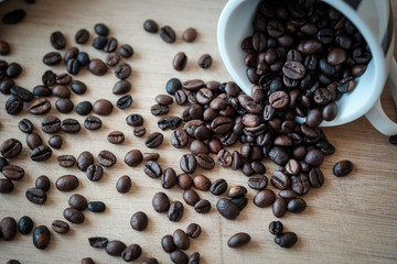 Detail view of coffee beans on wooden background. Macro shoot.