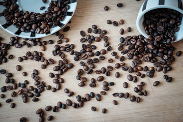 Detail view of coffee beans on wooden background. Macro shoot.