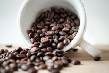 Detail view of coffee beans on wooden background. Macro shoot.