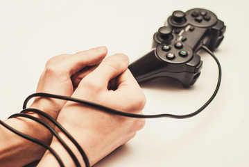 wired hands with joypad meaning videogame addiction © sponge_Po