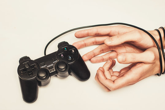 wired hands with joypad meaning videogame addiction