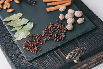nuts, spices and food on a wooden tray