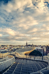 Tourists looking at view of skyline from Espacio Metropol Parasol, also known as La Setas,which is a wooden structure located at La Encarnación square, in the old quarter of Seville, Spain - 136551752