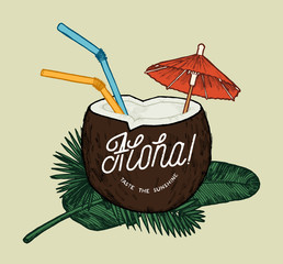 aloha tropical coconut cocktail with colorful straws and umbrella on jungle leaves.