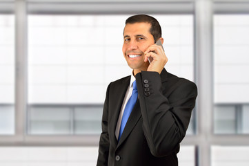 smiling executive talking by phone