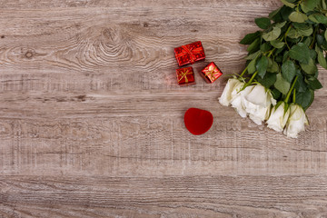 Roses with heart engagement box. Love design on wood background. Valentines day concept. Fresh natural flowers with gift boxes. Wooden rustic board.