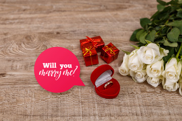 Roses with heart engagement box. Will you marry me design. Valentines day concept. Fresh natural flowers with gift boxes. Wooden rustic board.