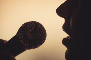 Woman singing to microphone