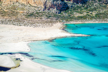 View of the amazing beach of Balos, with a family playing on the tropical sandy beach with turquoise waters, Crete, Greece