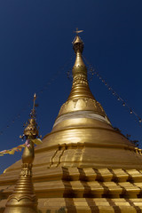 Fototapeta premium Amazing golden stupa, chedi and pagoda in buddhist temple in Thailand with deep blue sky background