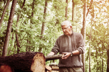 Man holding a tree trunk.