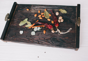 nuts, spices and food on a wooden tray