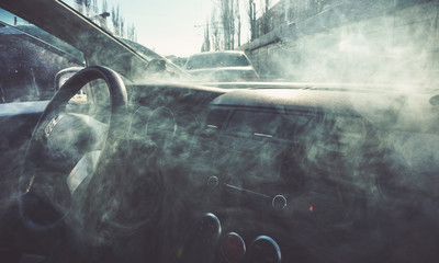 Car interior in smoke or vapour. Vape Inside car. Can be used as fire in automob