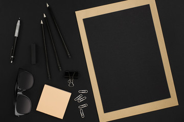 Office desktop with various black objects on  background