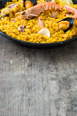 Traditional spanish seafood paella on wooden background
