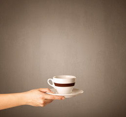 Female hand holding coffee cup