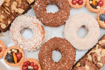 Doughnuts covered  with white and brown chocolate