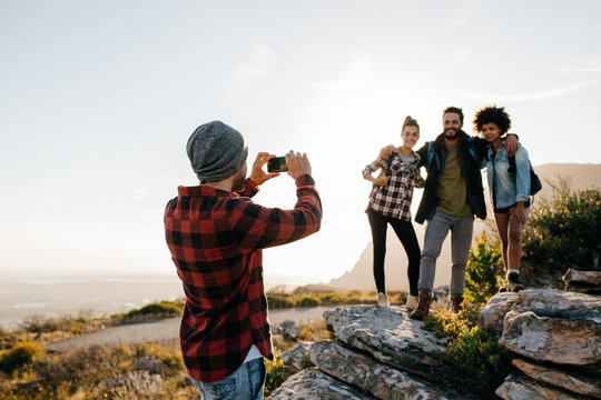 Group of people on hiking taking photographs
