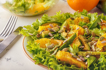Avocado orange salad with  pumpkin  and sunflower seeds.