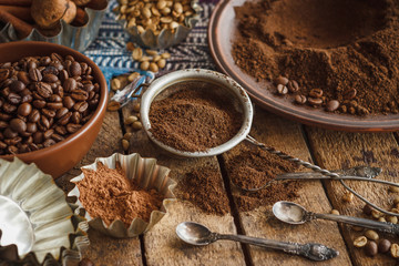 Roasted coffee beans and ground coffee in the plate