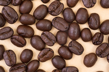 Top view of roasted coffee bean on wood texture background