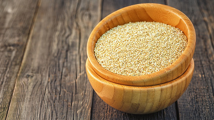 White quinoa in a wooden bowl.
