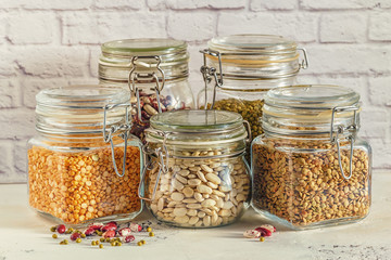 Glass jars with various legumes - beans, mung bean, peas and len