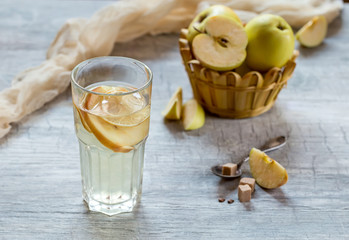 Apple compote in the glass. Apples in the background