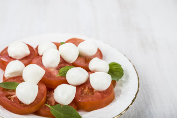 Caprese salad on a wooden table.