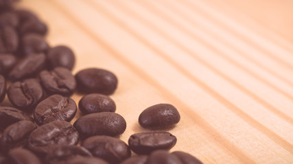 Selective focus of Roasted coffee bean on wood texture backgroun