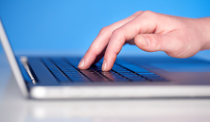 Close up of hand pressing keyboard buttons
