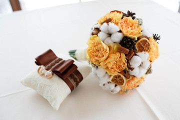 delicate bouquet of the bride and gold wedding rings