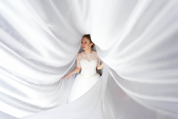 beautiful portrait of gentle bride in white dress