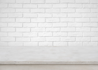 Vintage empty wooden table on defocused white brick wall background