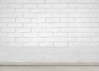 Vintage empty wooden table on defocused white brick wall background