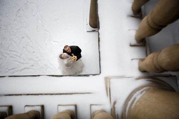 Beautiful bride and groom standing on a snowy street