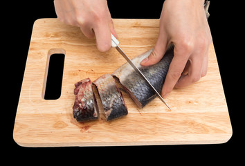 preparation of herring on a board on a black background